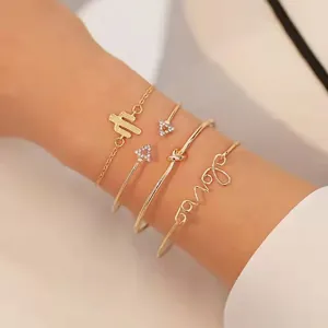 Detail of four-piece gold bracelet set with cactus charm, rhinestones and Love script