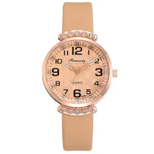 Detailed close-up of rose gold watch face with wave texture and crystal accents