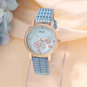 Elegant women's watch with blue floral dial and houndstooth strap in a professional shot