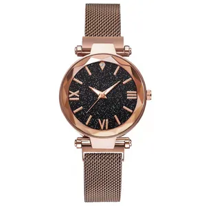 Detail of rose gold starry sky watch with magnetic mesh strap and faceted glass