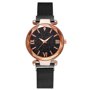 Detail of rose gold quartz watch with diamond-cut glass and black starry sky dial