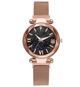 Detail of rose gold mesh watch with starry blue dial and faceted geometric glass face