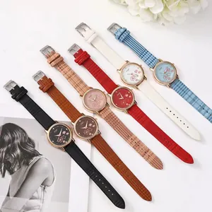 Flat lay of colorful women's quartz watches with floral dials and textured leather straps