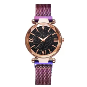 Detail of starry sky watch dial with mesh strap and faceted glass in rose gold finish