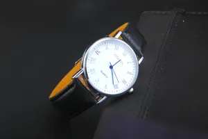Close-up of Geneva quartz watch with Roman numerals and black leather strap with yellow lining