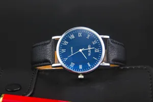 Detail of blue diamond-pattern dial with silver Roman numerals and black leather strap