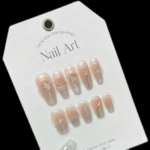 Handmade gradient pink press-on nails with silver glitter, pearls, and gemstone accents