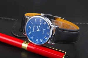 Detail of blue textured watch face with Roman numerals and black leather strap