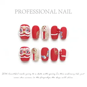 Macro detail of handmade red lion dance press-on nails with gold coins and 3D charms