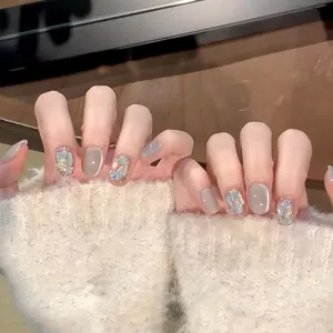Detailed view of cat eye press-on nails with aurora glitter and seashell shimmer textures