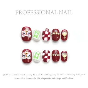 Detail of handmade red and white press-on nails with lion dance and heart design