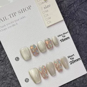Detail of glitter cat eye press-on nails in extra short and short coffin shapes