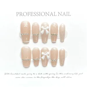 Detail of pink jelly press-on nails with white 3D bows and silver glitter gradients