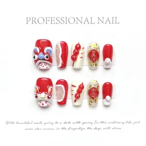 Detail of red 3D New Year press-on nails with lucky lion and festive gold foil accents