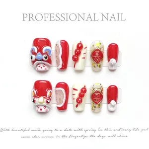 Detail of handmade 3D lion dance press-on nails with festive red and gold Chinese motifs