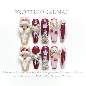Close-up of handmade 3D Christmas press-on nails with red Santa Claus and pearls