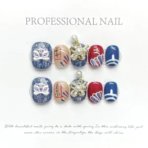 Detail of handmade press-on nails featuring 3D lion dance and floral pearl ornaments
