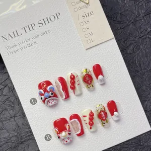 Handmade red New Year press-on nails with 3D lion dance and gold foil relief details