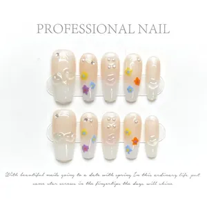 Macro detail of handmade floral press-on nails with 3D embossed patterns and pearls