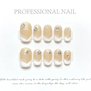 Detalle de 10 uñas press-on estilo francés nude con puntas blancas y pequeños brillantes