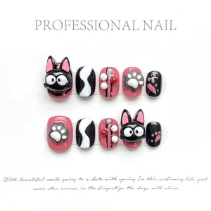 Macro view of handmade 3D cartoon cat and paw prints on pink and black press-on nails