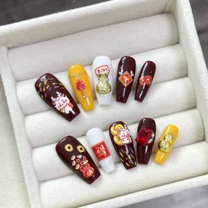 Handmade Chinese Dragon Year press-on nails with 3D gold charms and festive red patterns