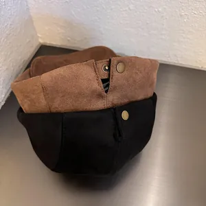 Minimalist suede newsboy caps for women in brown and black with metal button detail