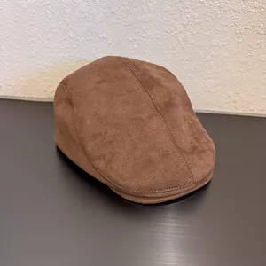 Detailed close-up of dark brown suede beret hat showing soft texture and neat stitching
