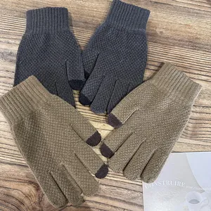 Thick knitted touch screen gloves for men in dark grey and camel on wooden background