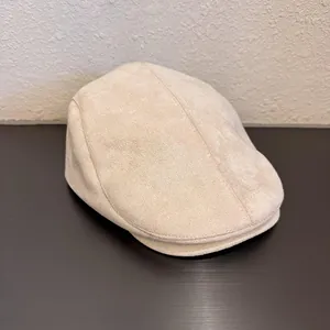 Detail view of beige faux suede flat cap with premium stitching and structured brim
