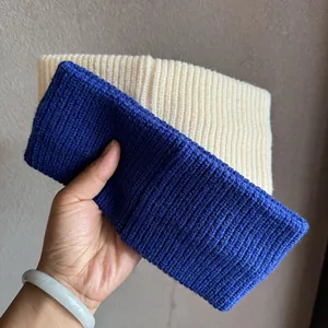 Close-up of navy blue and off-white ribbed knit headbands showing elastic soft texture