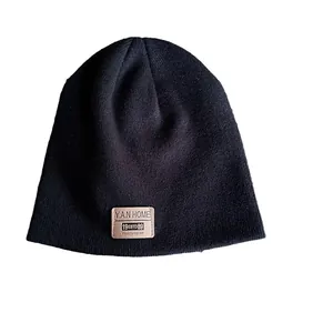 Unisex black knitted beanie hat with leather label patch for winter street style