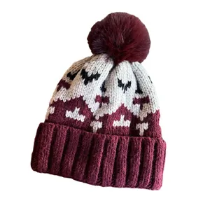 Retro pixel-style knit beanie with a wine red pom-pom and geometric jacquard pattern