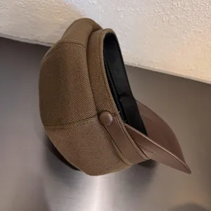 Brown wool newsboy cap with premium leather visor and textured cloud-shaped crown for women