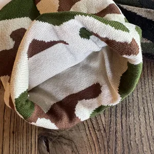 Close-up of camouflage knitted beanie showing warm inner lining and premium texture