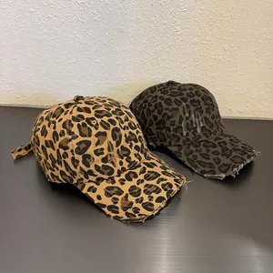 Detailed view of leopard print baseball caps with distressed edges and vintage finish