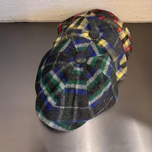 Classic British style plaid newsboy caps in green, yellow, and red woolen fabric for winter