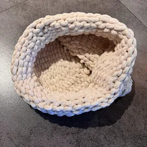 Macro view showing the thick chunky knit texture of the soft white chenille pet basket