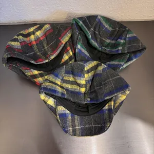 Detailed view of assorted plaid newsboy caps in wool blend for men and women