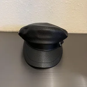 Retro black faux leather baker boy hat with classic flat top and silver metal buckle detail