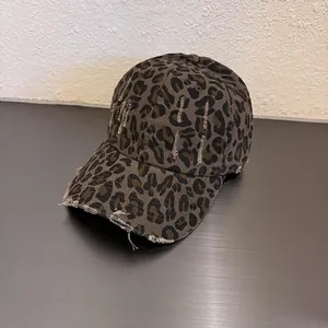 Close-up of leopard print baseball cap with vintage distressed ripped edge details