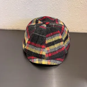 Close-up of the vintage wool blend newsboy cap with classic red and yellow plaid pattern