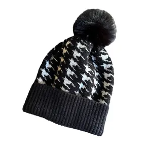 Women's vintage houndstooth knit beanie with a cute black pompom for winter warmth