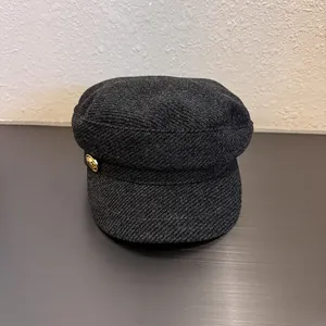 British style wool newsboy cap in dark charcoal grey with vintage gold metal button