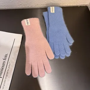 Detailansicht von rosa und blauen Plüsch-Strickhandschuhen mit weicher Fellstruktur