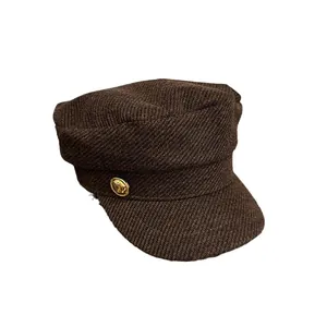 Classic dark brown wool baker boy hat featuring a vintage gold button and twill texture