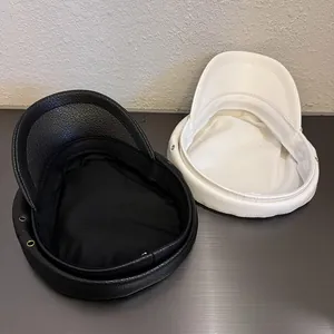 Vintage PU leather newsboy caps in black and white with classic textured finish