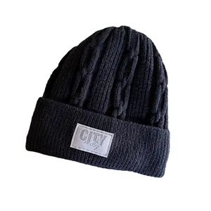 Classic black cable knit beanie for winter with fold-over cuff and CITY logo patch