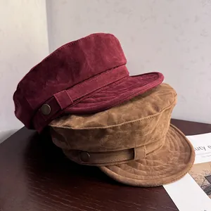 Vintage suede newsboy caps in burgundy and brown with metallic button detailing