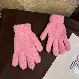 Detail of pink coral fleece gloves showing soft plush texture and elastic cuffs